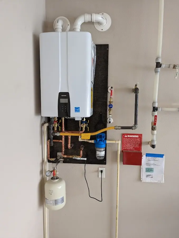 Professional plumber installing copper piping in a Victorville home